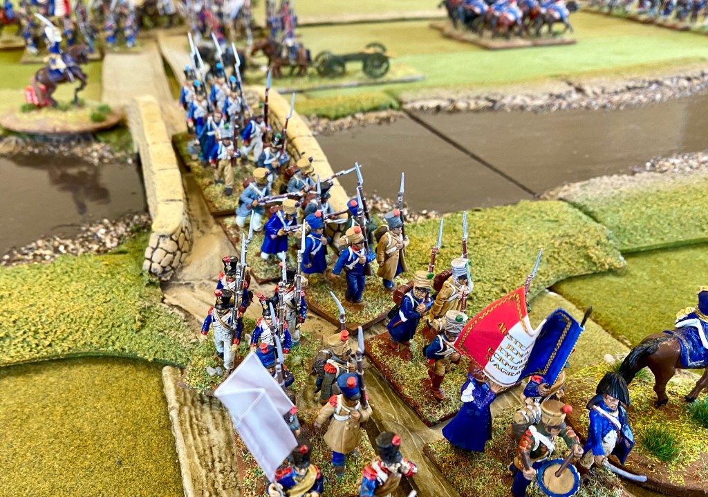 French line infantry pour across the only bridge across the river.