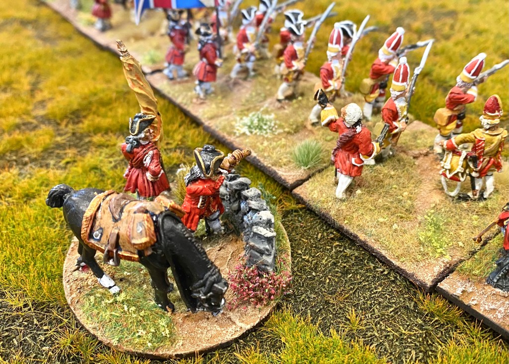 One of the Hanoverian commanders uses his eye-glass to inspect the Jacobites forming up across the moor. 