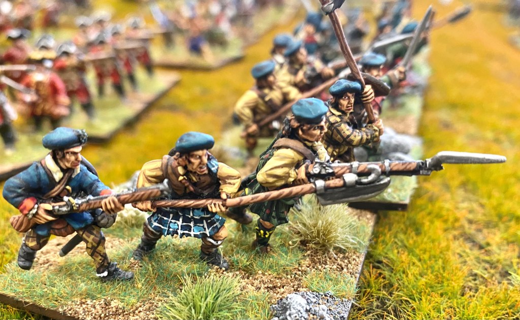 Jacobites with an eclectic mix of weapons advance on the Hanoverian line.